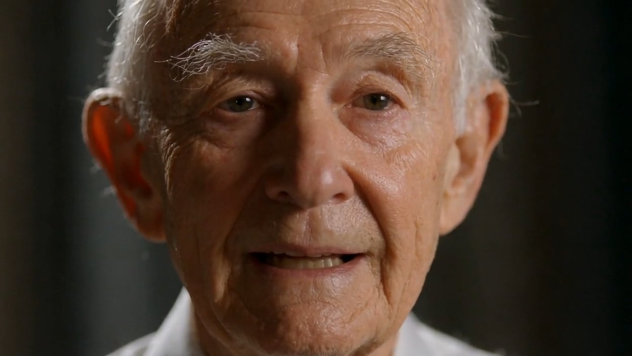 MIMIC AI - Create a photorealistic cinematic close-up of an older man speaking…